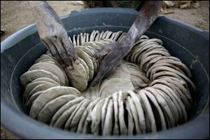Dried mud cookies are arranged for sale in Port-au-Prince, Haiti. They are made from dirt, salt, and vegetable oil.
