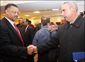 The Rev. Jesse Jackson shakes hands with John Nixon, president of the City Council, during his visit to Lima yesterday. (THE BLADE/AMY E. VOIGT)
<br>
<img src=http://www.toledoblade.com/graphics/icons/photo.gif> <b><font color=red>VIEW</b></font color=red>: <a href=