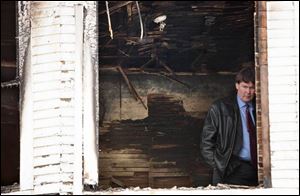 Detective Jay Gast investigates the scene of a fire at 1025 Marmion Ave., where the body of Gordon Wright was found. Wright Albert Richardson, a friend of Gordon Wright, leaves the burned house after speaking with Toledo police detectives.