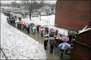 Hundreds of people line up outside the Toledo Technology Academy, where they hoped to see former President Bill Clinton.
