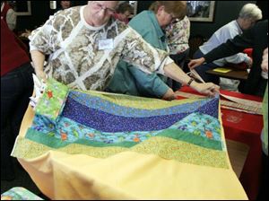 nbrw linus21p     2/16/2008         The Blade/Herral Long    NANCY FOWLER OF SYLVANIA  with pinned quilt  Please get fotos during Make a Blanket Day for Project Linus, Toledo/Lucas County Chapter, from 10 a.m. to 3 p.m. at Charlie's Pizza in Saxon Square. Want fotos of people making the blankets that will be given to the Lucas County Children's Services for distribution to foster children. Some people will be sewing blankets, others will be doing their work without the aid of machines. Sponsors are donating machines, scissors, space, money, etc., for blankets. About 40 were made during Blanket Day last year, and the chapter hopes to make more this year.
