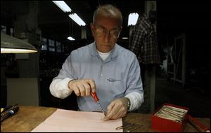 Randy Christy assembles a brand-new but antique pocket knife. 