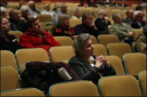 Tiffin resident Jan Dundore listens as panel members discuss the $8.5 million bond issue on the March 4 ballot.