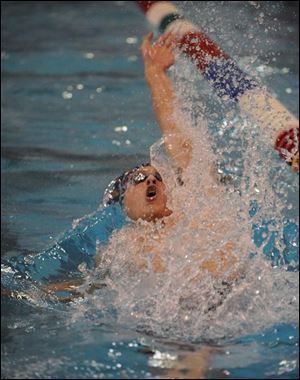 St. John's Jake Epperson kicks up some spray in winning the backstroke leg of the 200-yard individual medley at Canton.