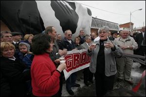 A crowd gathers around the fiber-glass bovine mascot, Sterlena.
