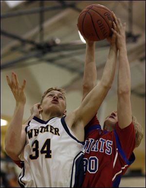 Whitmer's Zak Teel gets stop by St. Francis' Brody Henry while going to the basket in the Panthers' victory.