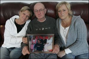 Dawn Turk, left, and her sister, Barbie Patton, sit with their father, Leroy Hubley. The family believes the faulty heparin in kidney dialysis caused the deaths of two family members.