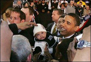 Sen. Barack Obama (D-Il) at the University of Toledo on Sunday stops to see a baby he noticed during his address to about 9,000 people at Savage Hall. Obama made his away around the crowd following his campaign stop.