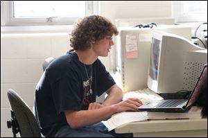 Andy Kissling uses a computer to design schematics for the school buildings.
