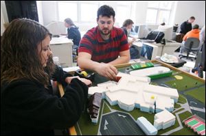 Above, Clay High School computer-aided drafting and design students Elizabeth Schenk, left, and Mychael Wagoner work on an architectual model of the school.