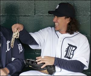 Tigers right fielder Magglio Ordonez holds up the chain and Old English 'D' he wore into the dugout as a joke yesterday.