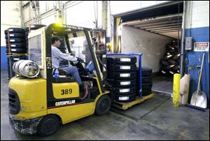 Newly manufactured tires are loaded for shipment at the Findlay firm that reported a $120 million profit for 2007.