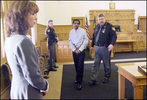 Michael Lee Dixon, 50, indicted for the murder of BGSU student
Karen Sue Hirschman, is escorted into a courtroom.
