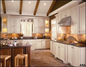 Mixing finishes like American Woodmark s Savannah Maple Butterscotch on the main cabinetry and Savannah Cherry Chocolate on the island is an easy way to add depth and color to any kitchen design.