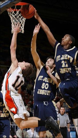 With Chad Stein also in position, St. John's Jay Springs blocks a shot by Southview's Tim Hausfeld.