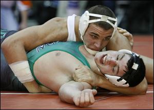 Southview's Greg Isley, top, scores on Andrew Tumlin of
Harrison to reach the Division I state final at 189 pounds. Oak Harbor's Keith Witt, top, works for a takedown en route to defeating St. Paris Graham's Zac Thomusseit at 171 pounds.
<img src=http://www.toledoblade.com/graphics/icons/photo.gif> <b><font color=red>VIEW</b></font color=red>: <a href=