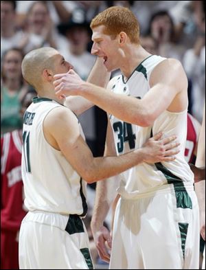 Michigan State seniors Drew Neitzel, left, and Drew Naymick embrace before leaving a home game for the last time.