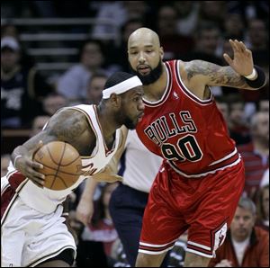 Cleveland's LeBron James, left, goes up against a former teammate, Drew Gooden, en route to scoring 37 points.