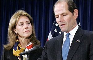 New York State Gov. Eliot Spitzer announces his resignation as wife Silda looks on Wednesday in his offices in New York City.