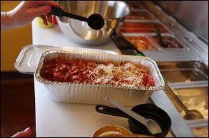 A pan of fresh lasagna made by a customer at Super Suppers will be sealed, taken home, frozen, then eaten at a later date.
