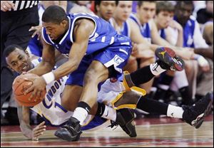 Chillicothe's Anthony Hitchens gets to the basketball before Libbey's Brandon Ham yesterday at Value City Arena.