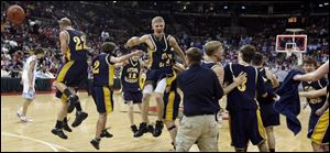 Ottawa-Glandorf players react to winning the Division III state boys basketball championship Saturday night with a victory over Sugarcreek Garaway.
