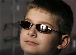 Carsen Pharis, 8, looks cool in his Aspex wire frame glasses with magnetic clip-on sunglasses.