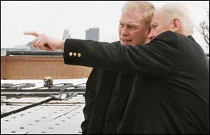 Mayor Carty Finkbeiner, right, makes a point to Gov. Ted Strickland as solar panels are installed atop the art museum.

