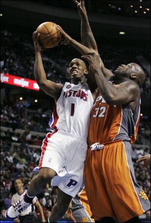 Detroit's Chauncey Billups drives to the basket against Phoenix's Shaquille O'Neal. The Suns had won seven straight.