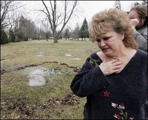 Shelley Deiley is heartsick about the water standing over her husband David's grave at Ottawa Hills Memorial Park.