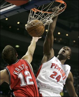 Detroit Pistons forward Antonio McDyess, right, dunks over New Jersey forward Nenad Krstic in the first half.