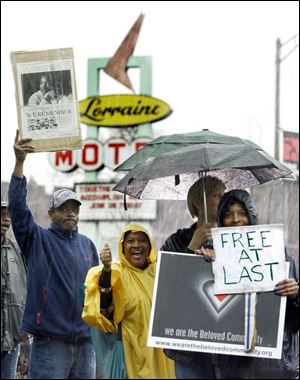 Outside of the Lorraine Motel, the site of Martin Luther King's assassination 40 years ago yesterday, marchers in the rain hold signs reflecting their thoughts, hopes, and prayers.