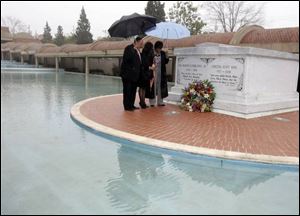 Martin Luther King III, left, his wife, Arndrea, and sister, the Rev. Bernice King, pray at Martin Luther King, Jr.'s tomb.