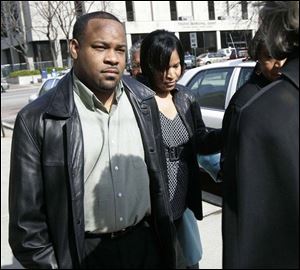 Bishop Lawrence Hancock escorts his wife, Karyn McConnell Hancock, into Toledo Municipal Court for sentencing.