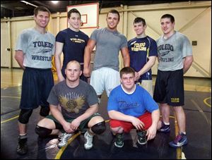 The University of Toledo Wrestling Club's members are, back row, from left, coach Matthew Rempe, Luke Nye, Drew Metzger, Tom Kiefer, and Adam Murray, and front row, from left, Matt Marek and Jeff Piotrowski. 