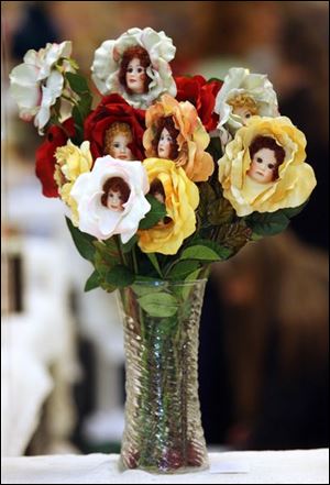 Slug: CTY dolls14p                Date: 4/13/2008             The Blade/Amy E. Voigt       Location: Toledo, Ohio  CAPTION:  Victorian flower vases that contain porcelain doll faces are for sale in Linda Hess' stall at the doll show and sale sponsored by the Toledo Glass City Doll Collectors at the Stranahan Great Hall on April 13, 2008.  The event had dolls and valuables for sale and patrons could also have their dolls appraised for $3 each.