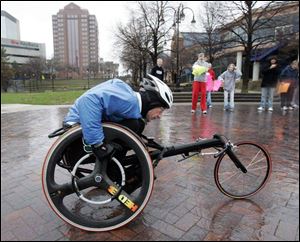 Andrew Barnhart, 52, of Reading, Mich., competing in the wheel division, nears the finish of the Glass City Marathon at Promenade Park in downtown Toledo. 