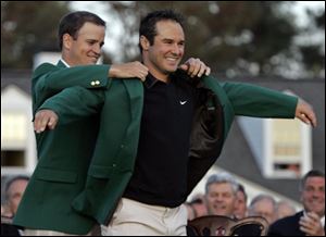 Zach Johnson puts the green jacket on Trevor Immelman of South Africa after Immelman won the 2008 Masters golf tournament at the Augusta National Golf Club on Sunday.