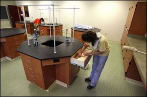 Deb Lewallen, front, and Tracy Davis, background, of Toni's Cleaning Service prepare a lab.