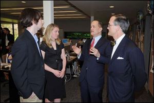 Daily Kent Stater Editor Bryan Wroten, from left, and TV2 News Director Kaitlyn Lionti speak with Allan Block and John Robinson Block at the opening of Franklin Hall at Kent State.