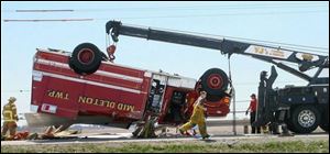 A Middleton Township water tanker flipped along Route 582 near I-75, trapping one firefighter.