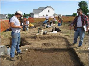 Brian Redmond, right, directs the excavation of a test unit. They have been able to follow the evolution of a transient fishing village into a stable farming community.