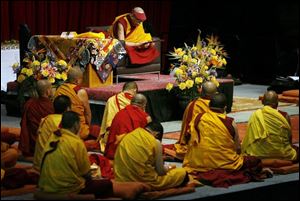 About 25 monks sat on the stage with the Dalai Lama. 