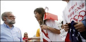 A man argues with Rica Li, a China native and now of Canton, Mich., after the session.