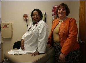 Dianne Mantel, an attorney with Legal Aid of Western Ohio, right, and Dr. Kimberly Artis of St. Vincent Mercy Family Care Center team up to resolve children's health issues that go beyond a doctor's care.