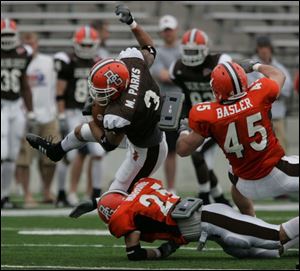 Marques Parks gets brought down by P.J. Mahone after grabbing a pass at Doyt Perry Stadium.
