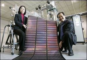 Xunlight founders Liwei Xu, left, and her husband, Xunming Deng, a professor at the University of Toledo, plan to expand the company s facility to make flexible solar panels.