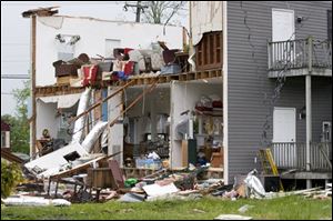 A house in Driver, Va., is shown after a tornado blew the side off it Monday.