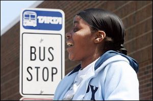 LaQuanda Brown waits for the bus that will take her to downtown Toledo from the Owens Community College campus.