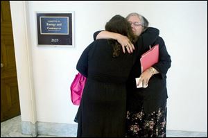 Johanna Staples, right, is hugged by daughter C.J. Leavens. 